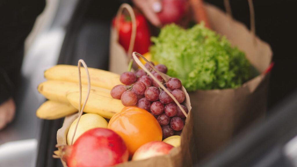 Grocery cart with fresh produce at a Murrieta supermarket, reflecting everyday cost of living in the area.