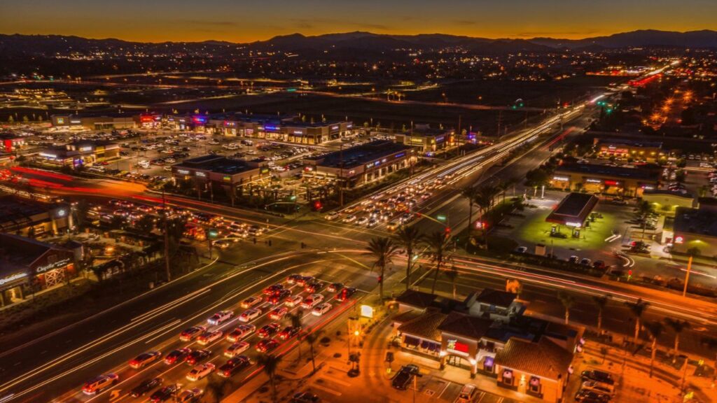 Cars lined up at a busy Newport Road intersection in Menifee during evening commute hours.