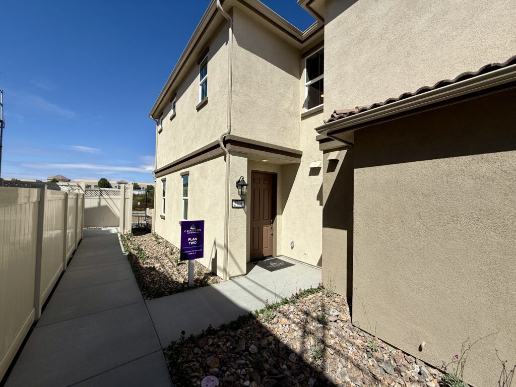 New construction single-family home in Menifee with desert landscaping, two-car garage, and solar panels on the roof.